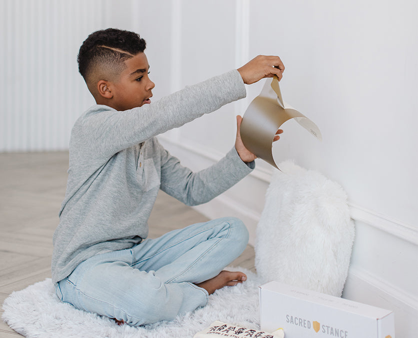 Boy sitting in Sacred Stance Prayer Space